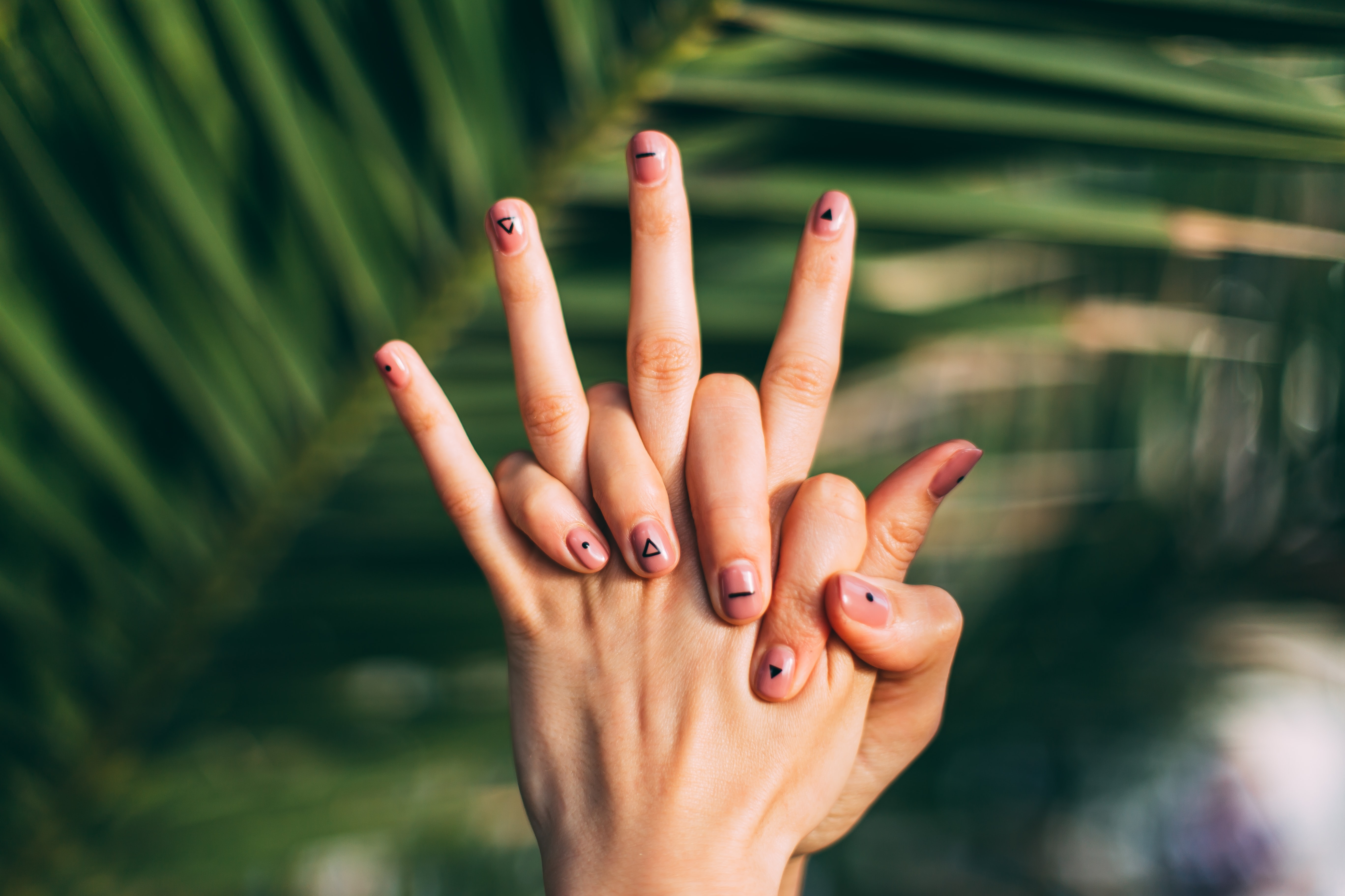hands with brown nail polish